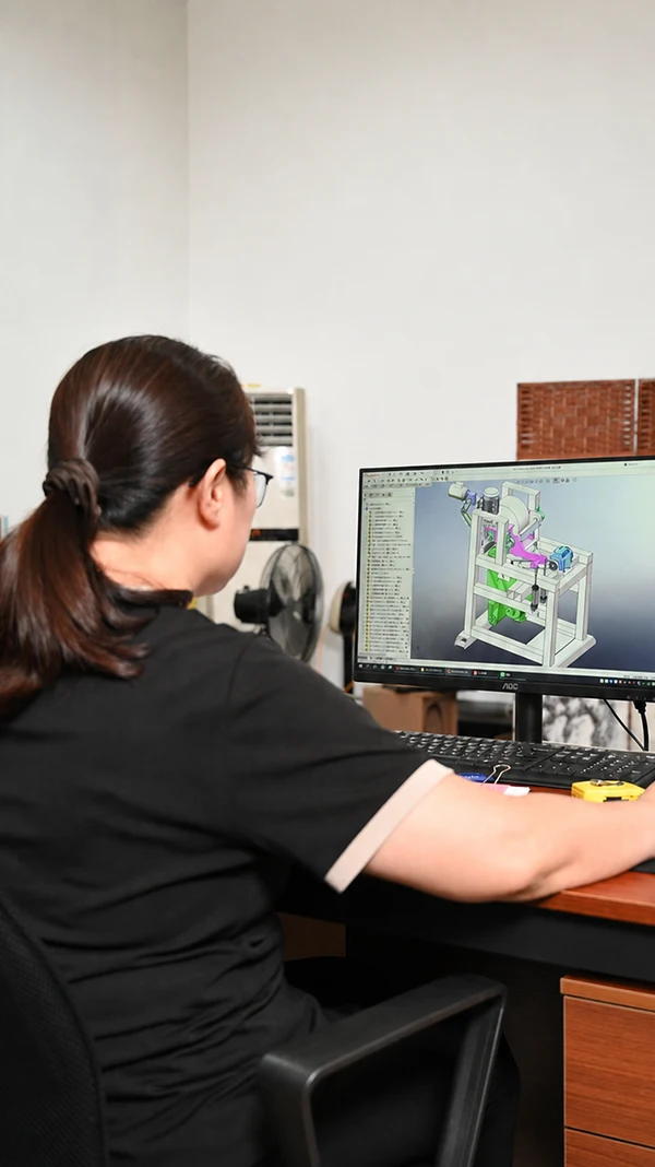 Engineer designing a sanding-machine assembly in CAD