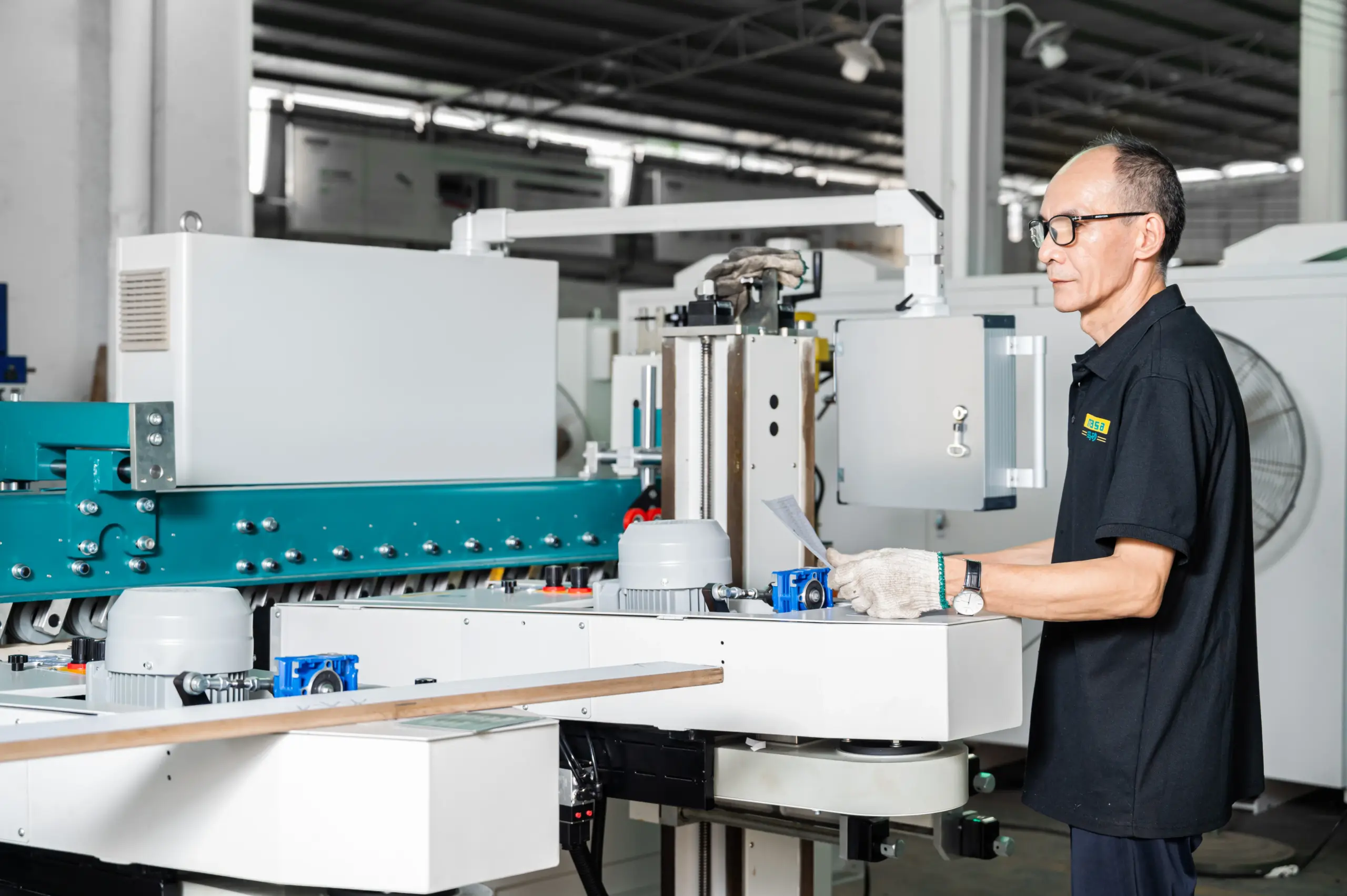 MASA engineer checking a custom sanding machine on the factory floor against the agreed specification
