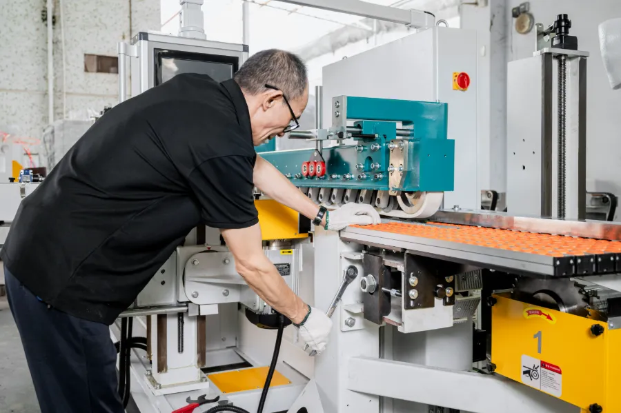 Technician adjusting a sanding machine during after-sales support