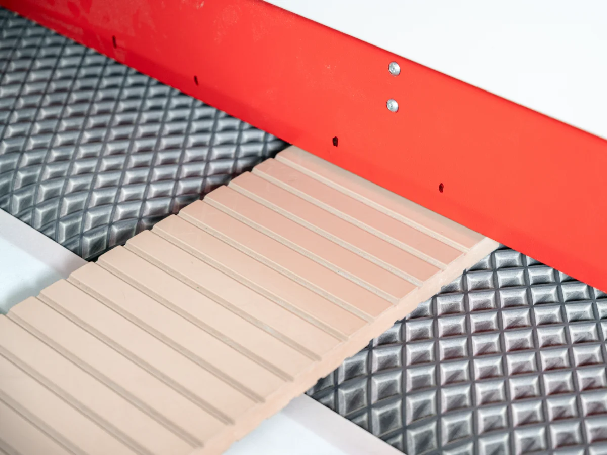 Wood panel, iron door section, aluminum profile, and stainless-steel sheet arranged beside an industrial sanding machine